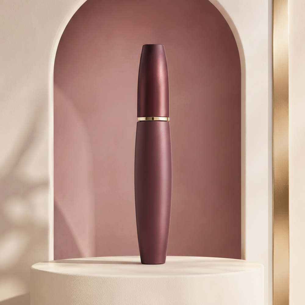 Open Trinidy MK Cloud Lash Tubing Mascara tube and wand displayed in a polished fig-toned studio