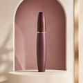 Open Trinidy MK Cloud Lash Tubing Mascara tube and wand displayed in a polished fig-toned studio